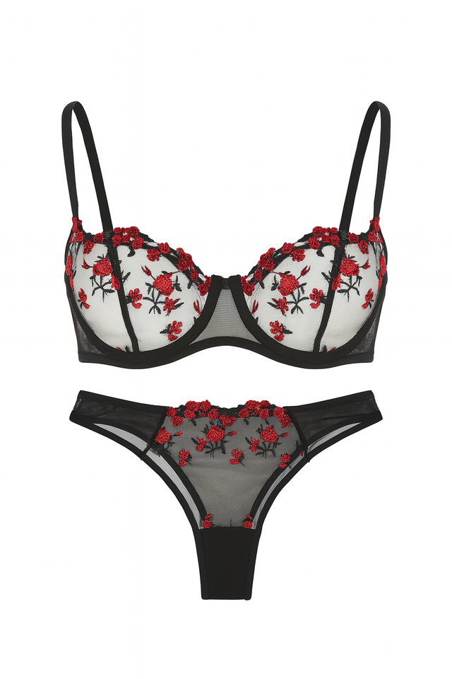 Black bra and panties set with red floral embroidery on a white background