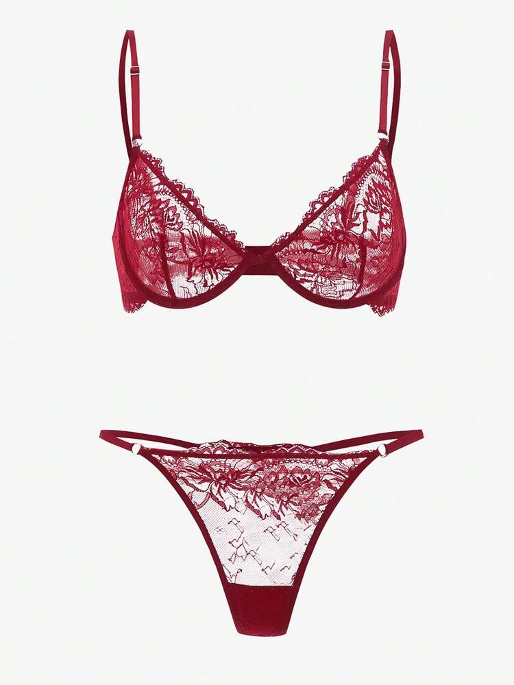 Red lace bra and panties set on a white background