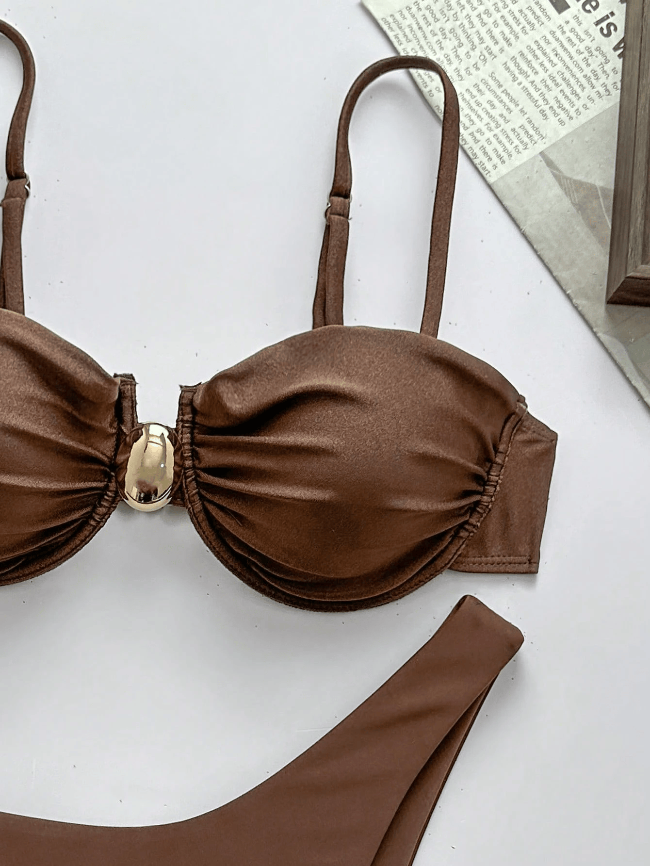 close-up of brown liberty bikini with ruched cups, slim straps, and gold-tone centre buckle