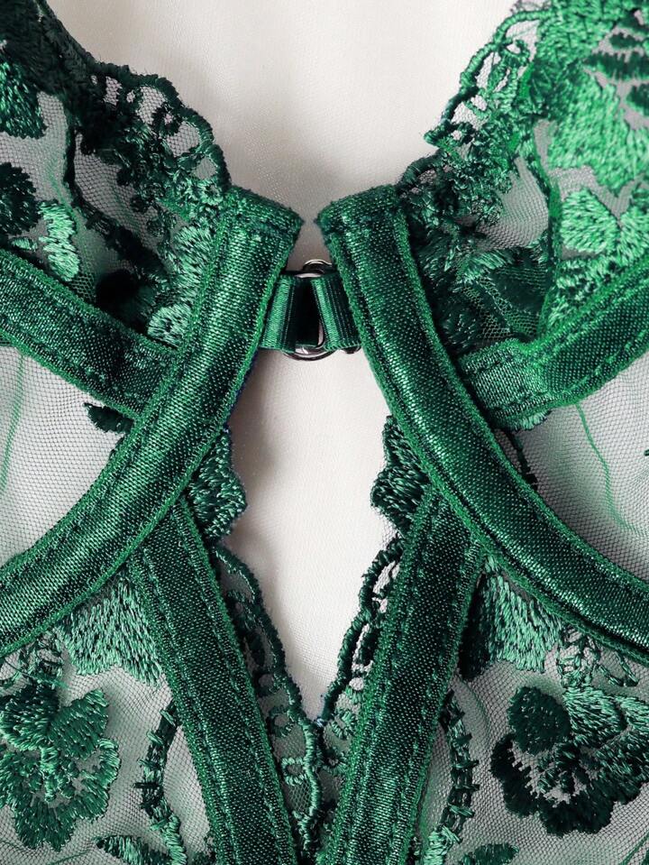 close-up of evangeline green lace lingerie bodysuit with crisscross straps and back clasp detail