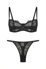 Black lace lingerie set displayed on a white background, featuring an underwired demi bra with sheer floral lace cups and matching low-rise lace thong with slim adjustable side straps.