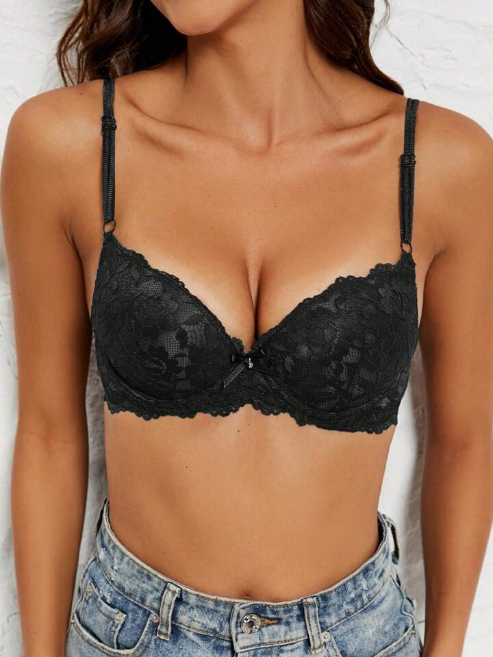 black plunge bra with lace cups, adjustable straps, scalloped trim and small center bow