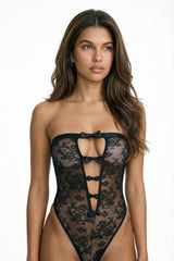 front view of sabrina black lace bodysuit with strapless neckline, front cut-out and bow accents
